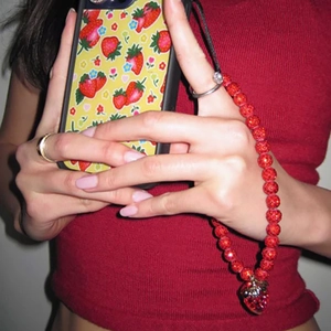 Detailed shot of handmade strawberry phone charm strap with sparkling crystal beads