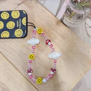 Pink mushroom phone strap with handmade beads white clouds and yellow smiley faces
