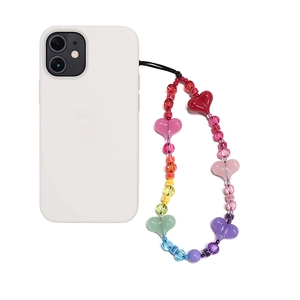 Rainbow heart beaded phone charm with colorful ceramic beads on a white smartphone
