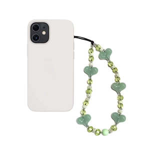 Detail of green ceramic rainbow beads and acrylic heart charms on a phone lanyard strap