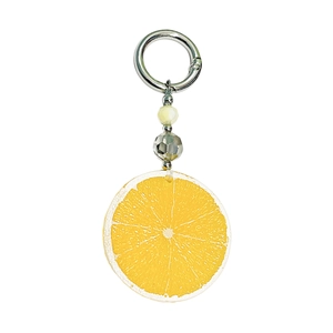 Detail view of yellow acrylic lemon slice keychain with beads and silver metal clasp