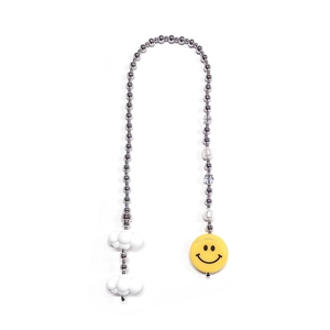 Close-up of beaded bag charm with silver balls, white clouds and yellow smiley face