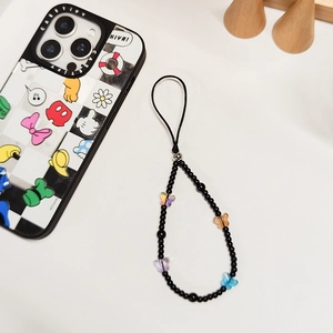 Handmade beaded phone strap with colorful crystal butterflies and black beads on white desk