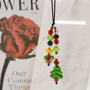 Handmade beaded Christmas tree phone charm with colorful stars for holiday bags