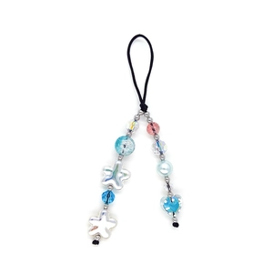 Colorful beaded phone charm with heart and star charms on a white background