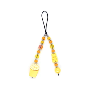 Detailed beaded phone strap with yellow bear and popcorn bucket charms on white background