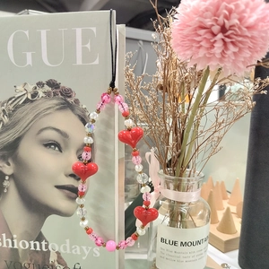 Handmade beaded phone strap with red hearts and pink pearls for a sweet aesthetic look