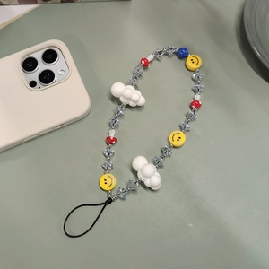 Beaded phone strap with white cloud and mushroom charms on a soft green background