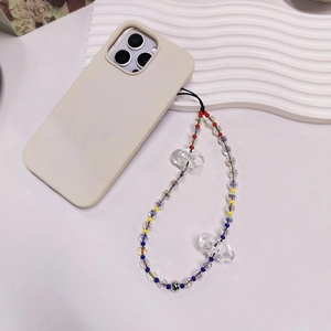 Close-up of beaded phone charm with acrylic bows and colorful beads on a phone case