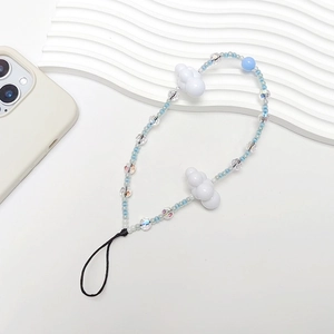 Blue and white beaded phone strap with cloud charms on a minimalist wave board