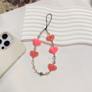 Pink and red heart beaded phone charm strap with crystal beads on a white background
