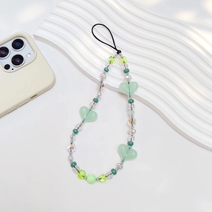 Green acrylic heart and pearl beaded phone charm strap with minimalist aesthetic design