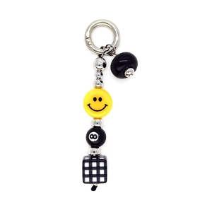 Retro keychain with yellow smiley face, 8-ball bead, and black-white checkered cube
