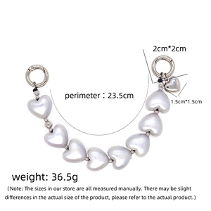 Detail view of the iridescent heart charm chain with spring ring buckles and metallic beads