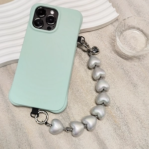 Detail view of mint green silicone phone case with silver heart-shaped pearl chain strap