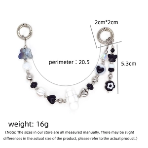 Black and white beaded phone charm with butterfly and heart charms with silver spring rings