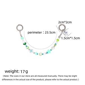 Green and white beaded phone strap with star, heart charms and silver spring rings