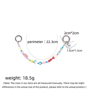Colorful beaded phone strap with heart pendant and floral charms in a symmetrical layout