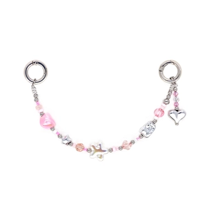 Detail of pink beaded phone chain with silver star beads and heart pendant on white backdrop