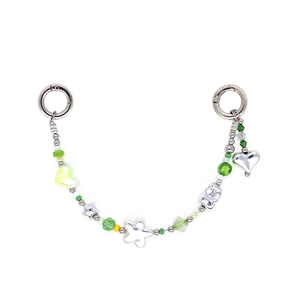 Detail view of colorful star and heart beads with silver spring clasps for phone or bag