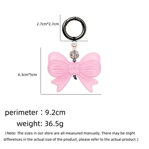Pink translucent resin bow keychain with beads and black spring clip for handbags