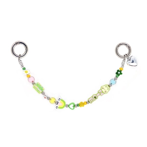 Detail of candy-colored beaded mobile strap featuring flower, heart, and frog charms
