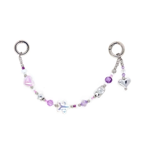 Detailed close-up of beaded phone strap with purple charms and silver heart pendant