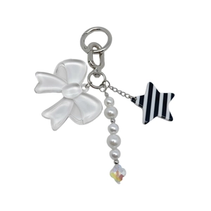 Detail view of bow, pearl beads and striped star charm on a silver metal keychain