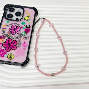 Pink butterfly phone strap with matte beads paired with a floral patterned iPhone case
