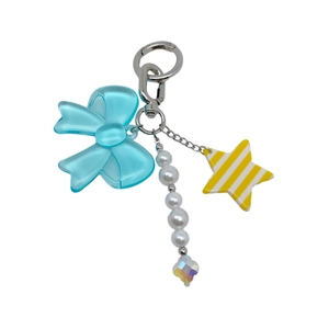 Detail of blue bow and yellow star charms on a beaded phone strap with lobster clasp