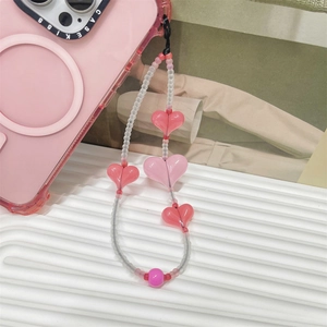 Pink heart beaded phone charm strap with frosted round beads on a minimalist background