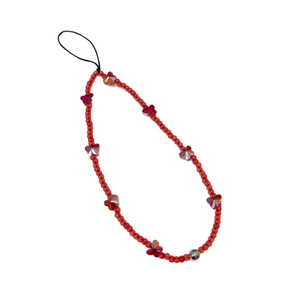 Handmade red beaded phone strap with translucent beads and butterfly charms on white backdrop