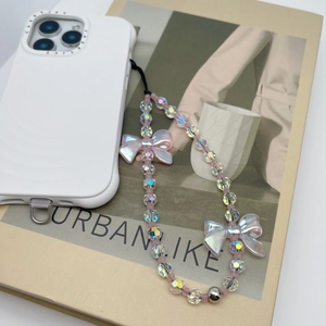 Detail of iridescent beaded phone strap with translucent bows on a white case
