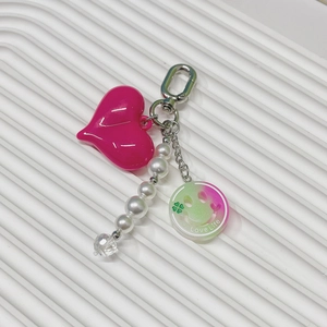 Close-up of pink heart keychain with white pearls and a colorful Love Life smile charm
