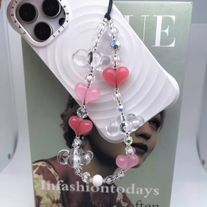 Handmade pink heart beaded wrist strap phone lanyard for women on a white case