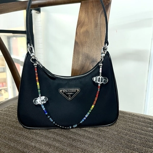 Black nylon baguette bag with colorful beaded chain and transparent cloud charms