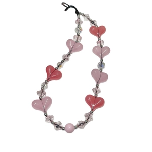 Pink heart-shaped crystal beaded phone wrist strap with silver accents on white background