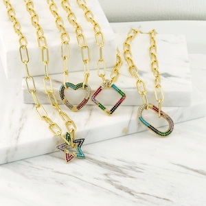 Detailed shot of gold link necklaces with rainbow zircon heart and star pendants