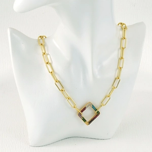 Detail of gold paperclip chain necklace with a colorful square zircon stone pendant