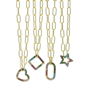 Detailed close-up of gold paperclip necklaces with colorful zircon heart and star pendants