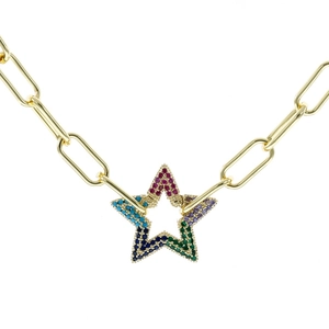 Macro detail of paperclip chain necklace with a colorful star pendant and rainbow zircons