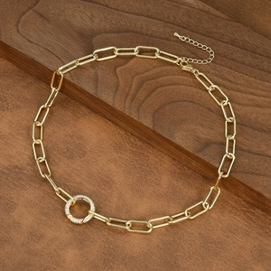 Detail of gold paperclip chain necklace with a sparkling cubic zirconia pave circle pendant