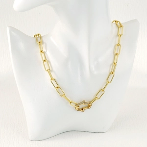 Detailed macro view of a gold-plated link chain with a sparkling crystal buckle pendant