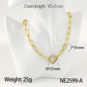 Detail of gold paperclip chain necklace with rhinestone buckle on white mannequin