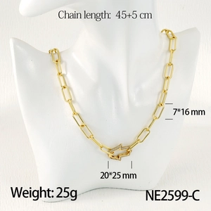 Detail of golden paperclip chain necklace with rhinestone encrusted geometric clasp pendant