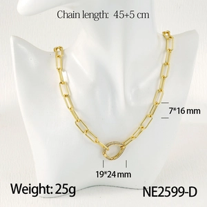 Detail view of a gold paperclip chain necklace with a crystal-encrusted oval clasp