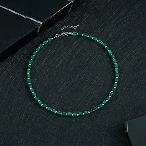 Detailed shot of beaded lapis lazuli necklace with square malachite beads and lobster clasp