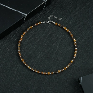 Detail of vintage beaded necklace with square tiger eye stones and metal spacers