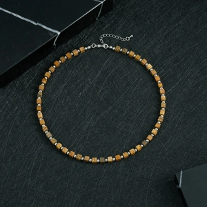 Detail of square tiger eye stone beads and silver spacers on a minimalist necklace