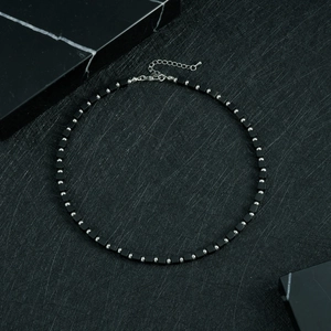 Detail shot of the matte black square beads and silver beads on the stainless steel necklace